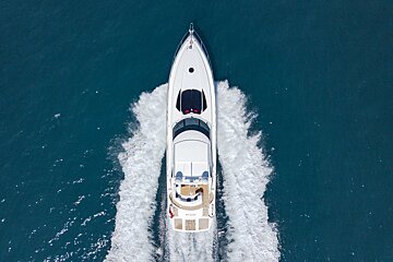 An aerial view of a white yacht with the word pearl on the front