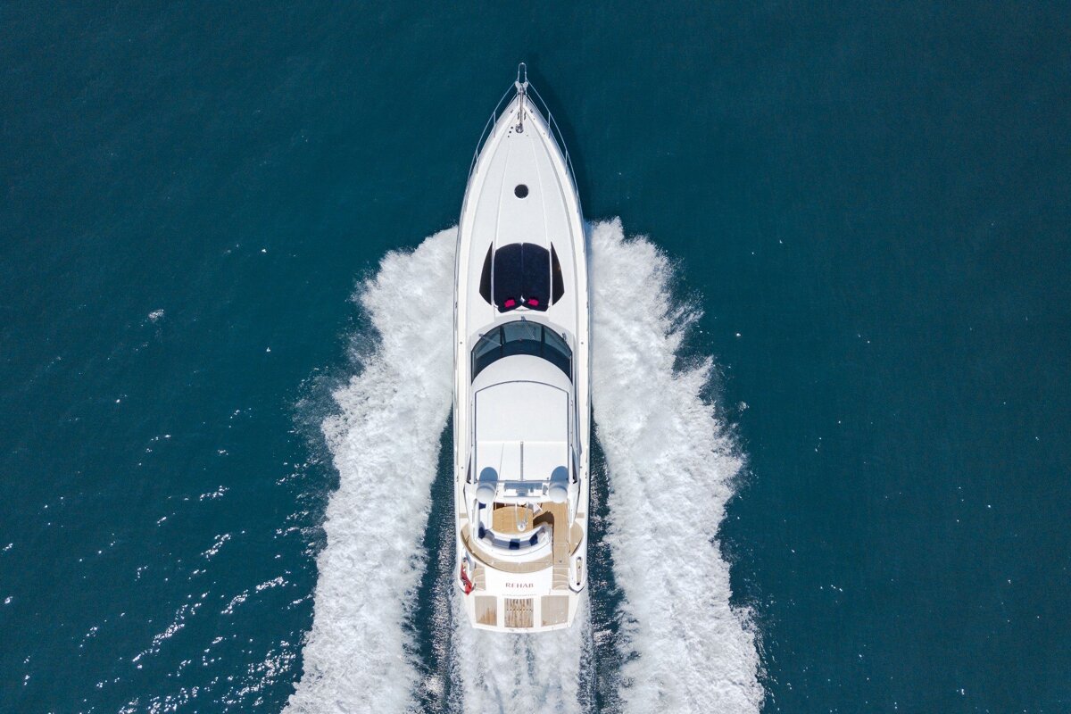 An aerial view of a white yacht with the word pearl on the front