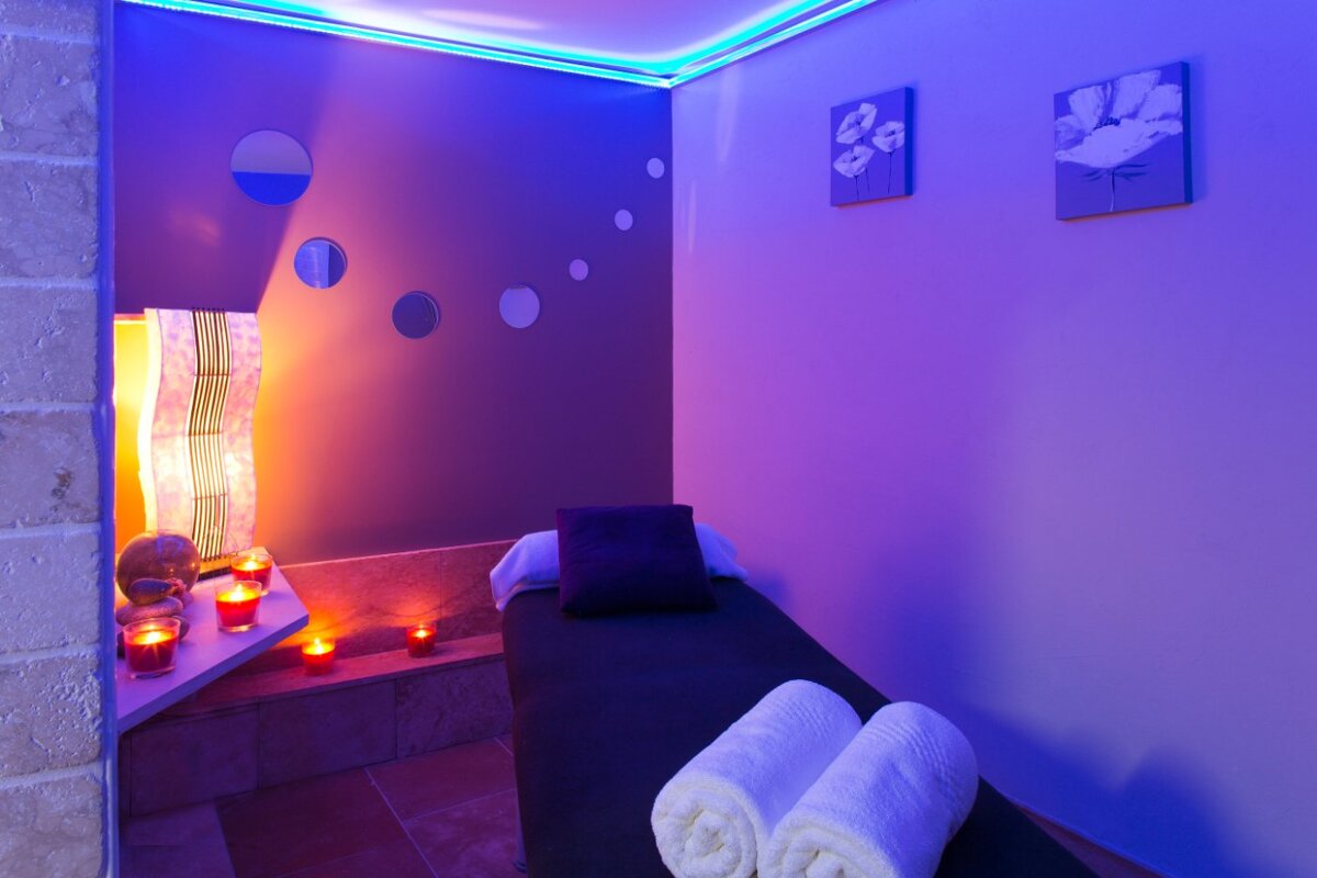 A room with a bed and candles in it