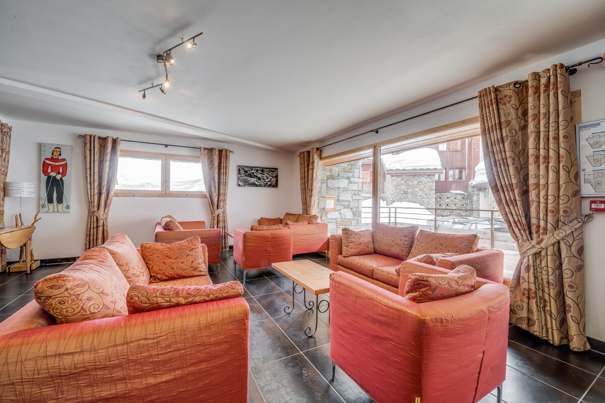 A living room with a fire extinguisher on the wall