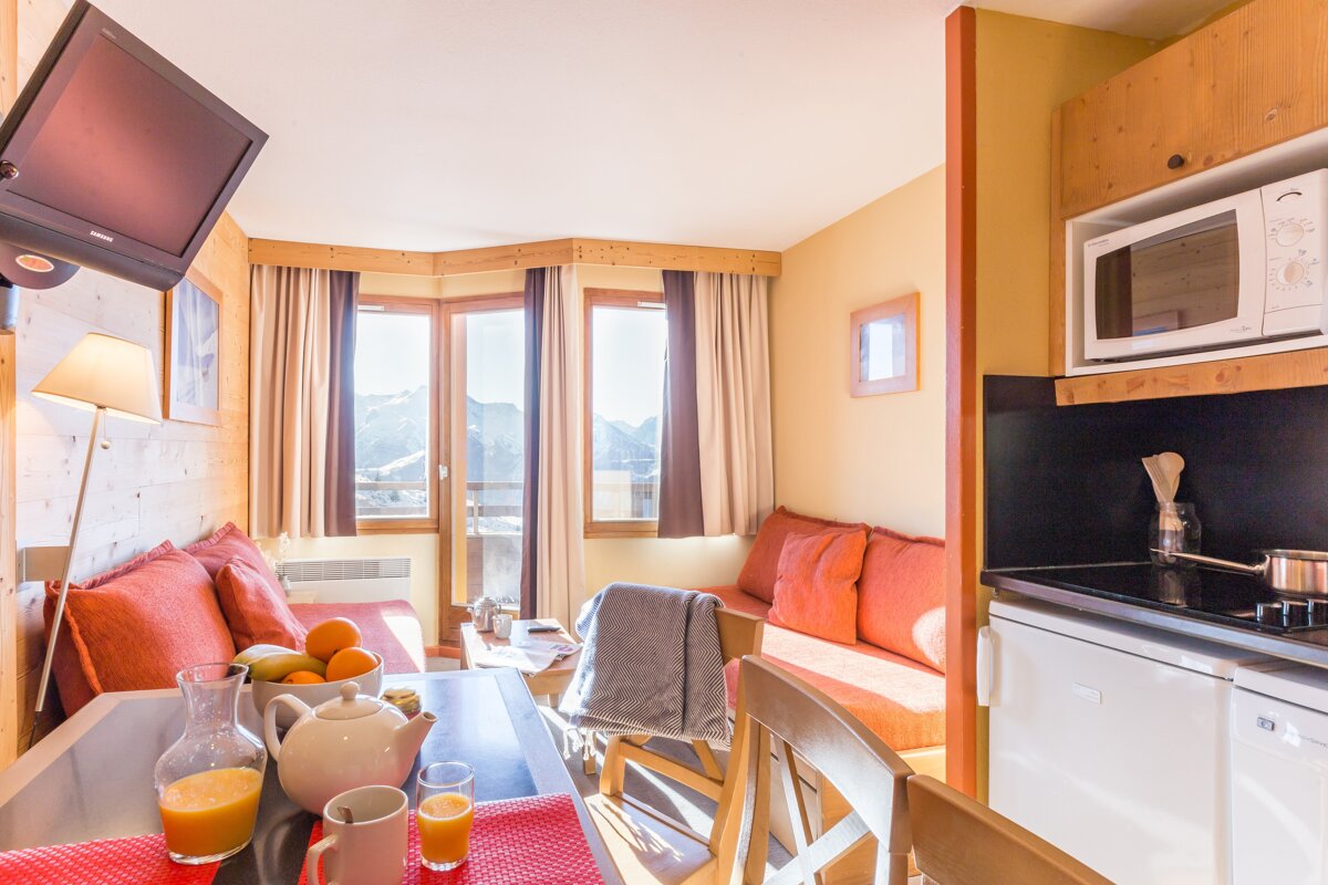 A living room with a flat screen tv and a microwave