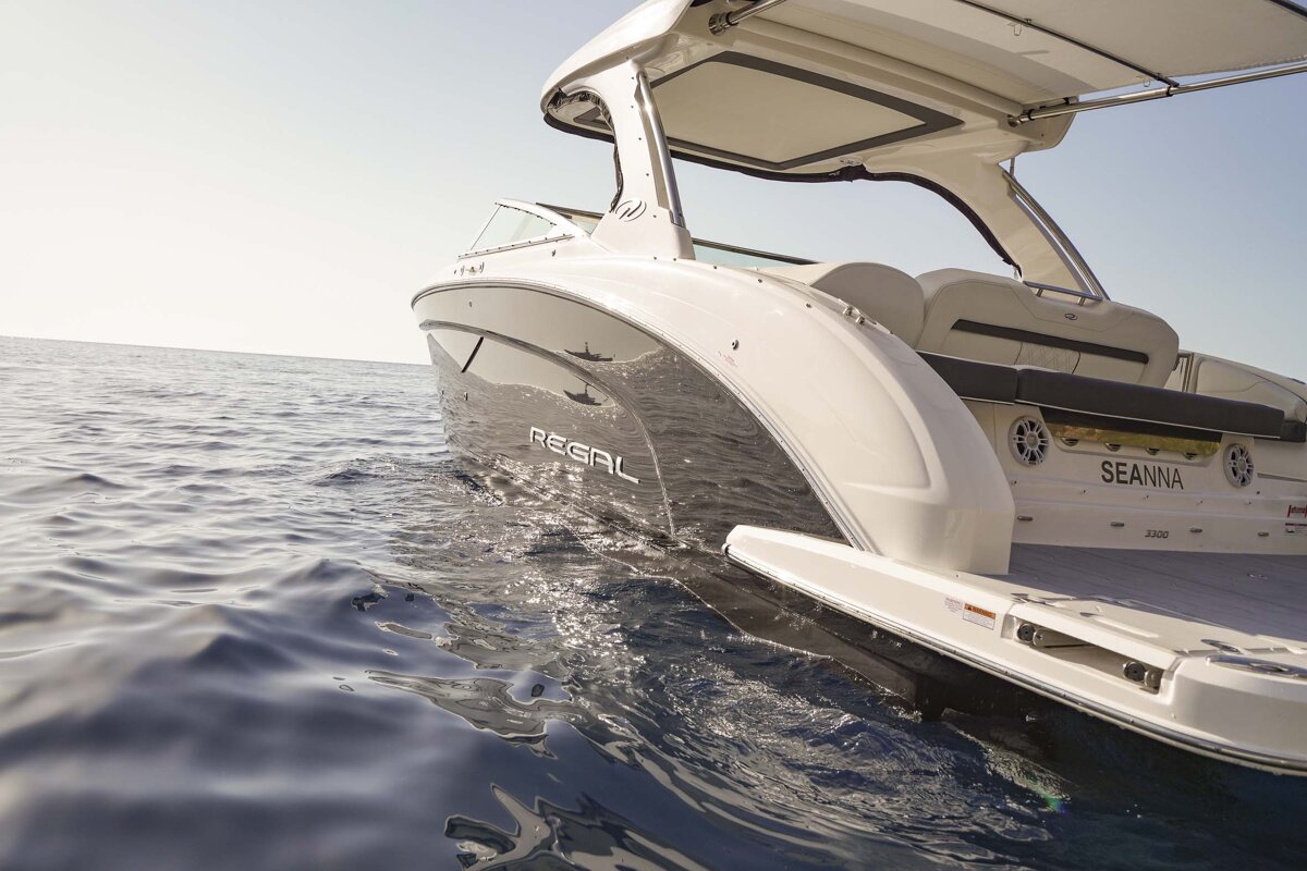 A sleek white and dark grey Regal boat named 