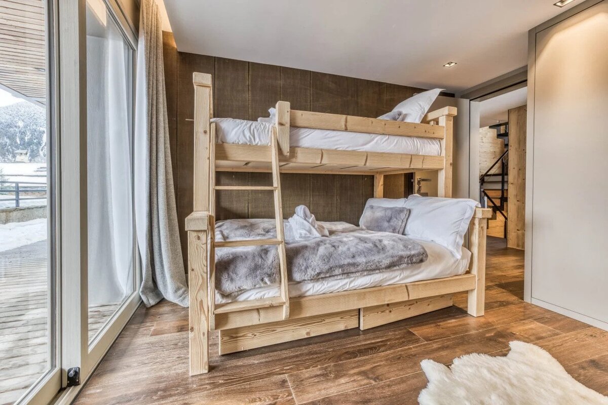A bunk bed in a room with a sliding glass door