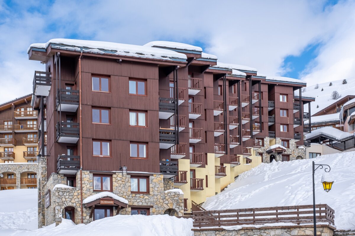 A snowy building with a sign that says ' hotel ' on it