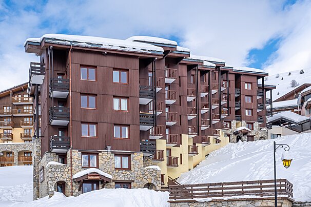 A snowy building with a sign that says ' hotel ' on it