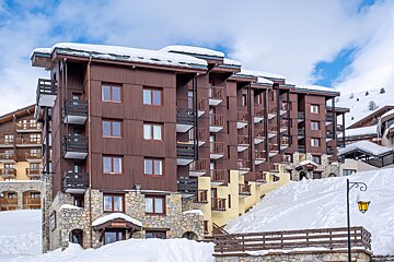 A snowy building with a sign that says ' hotel ' on it