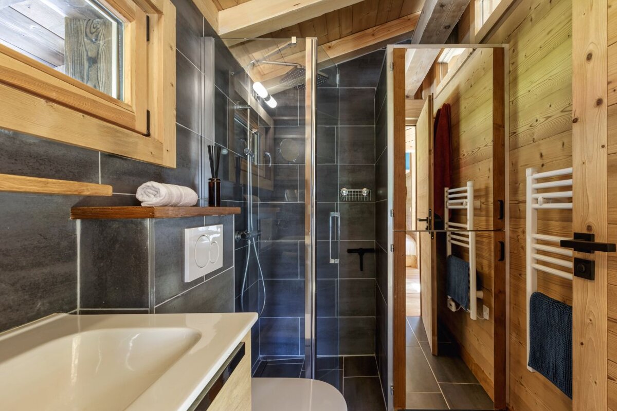 A bathroom with a toilet a sink and a shower