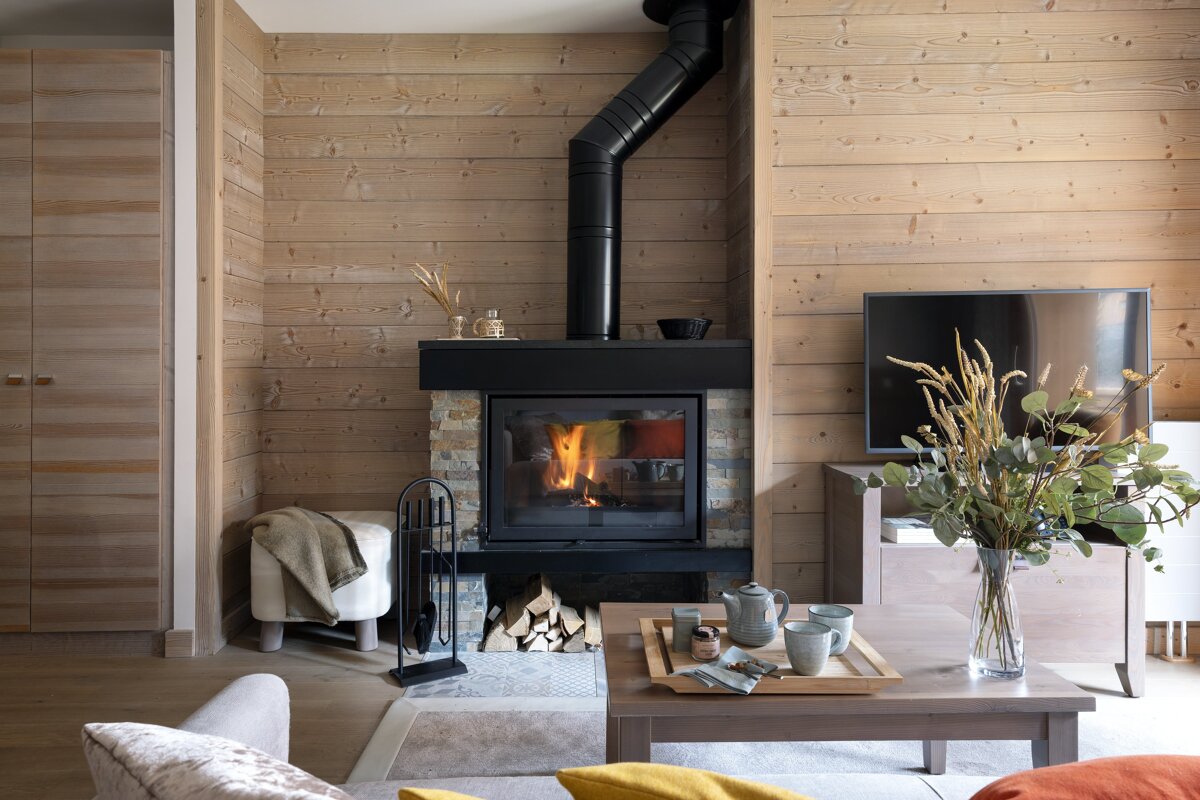 A living room with a fireplace and a tv