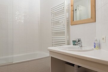 A bathroom with a sink and a towel rack