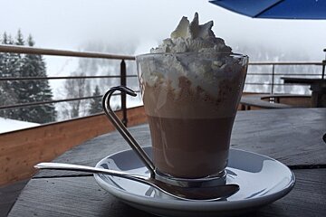 a glass of hot chocolate with cream
