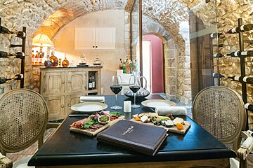 A table with plates and glasses of wine and a menu that says la cave paul