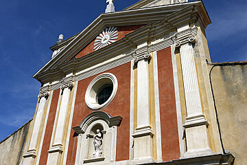 A church with a statue of a woman on the front