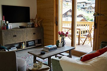 A living room with a coffee table and a tv