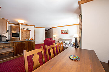 A living room with a dining table and chairs