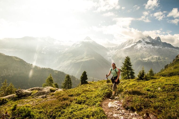 A woman hiking on a trail in the mountains