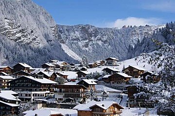 A small village in the mountains covered in snow