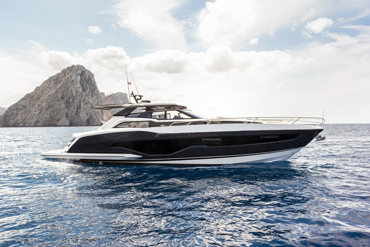 A black and white yacht is floating in the ocean