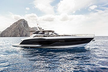 A black and white yacht is floating in the ocean