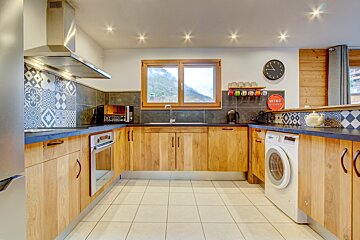 A kitchen with wooden cabinets and a sign that says wine