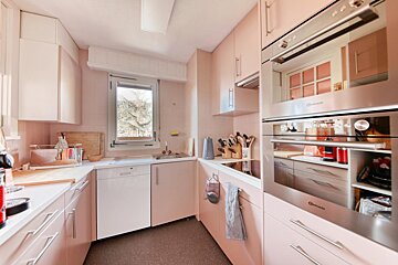 A kitchen with pink cabinets and a bauknecht oven