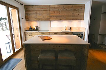 A kitchen with wooden cabinets and a white counter top