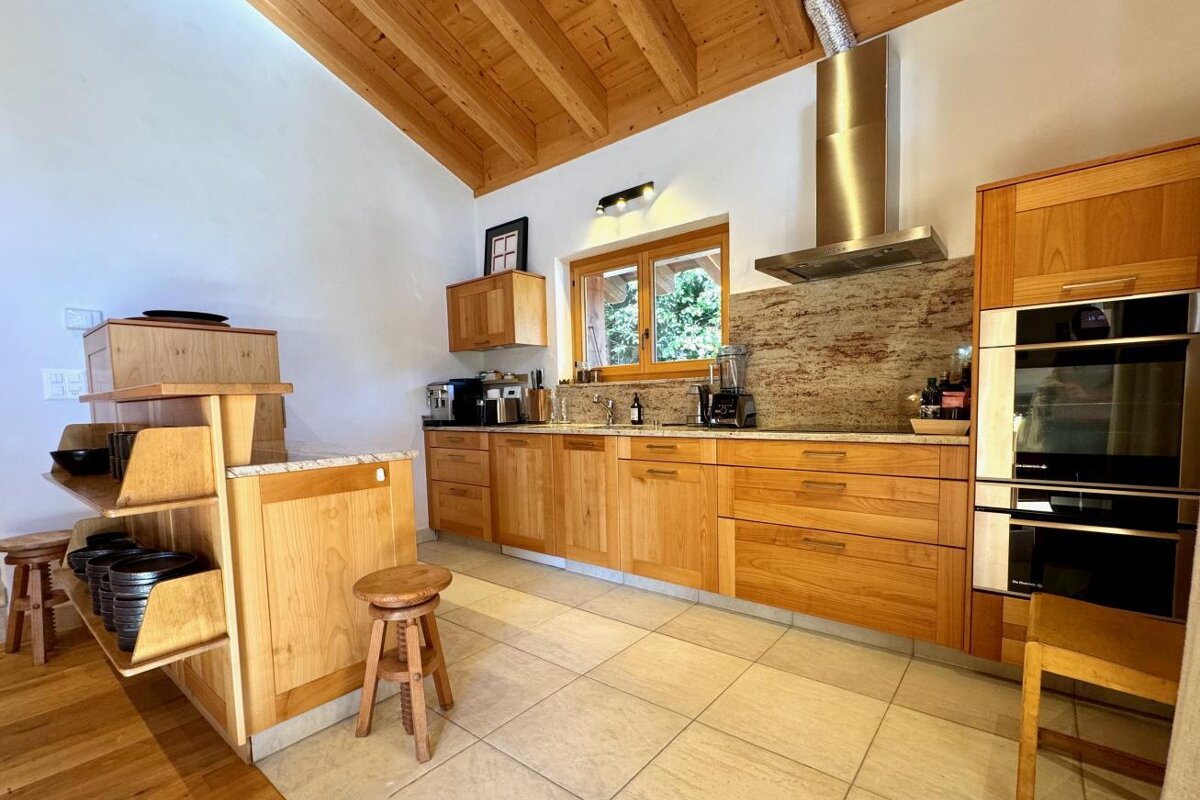 A kitchen with wooden cabinets and stainless steel appliances