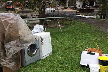 a flooded garden with kitchen white goods in it