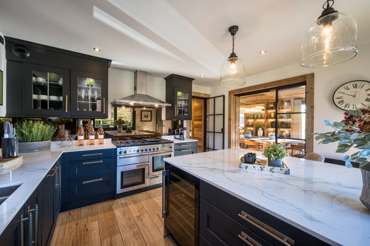 A kitchen with black cabinets and stainless steel appliances