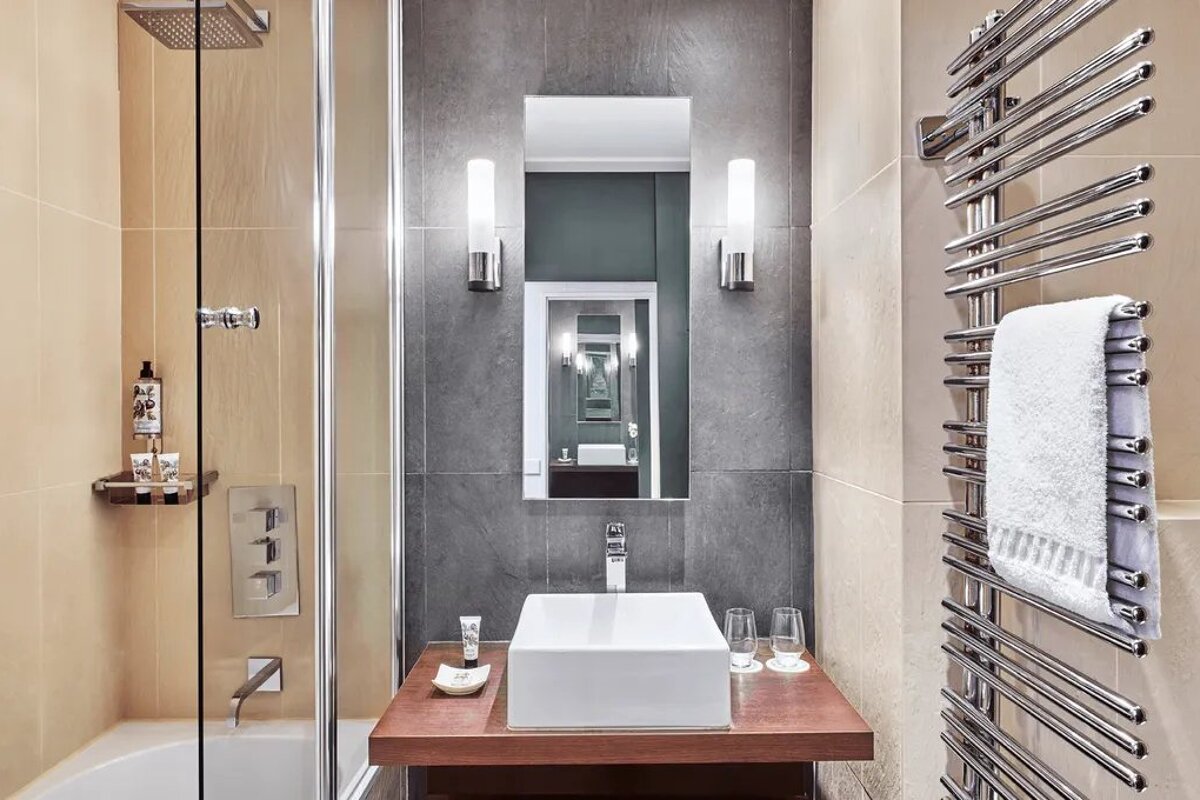 A bathroom with a sink and a towel rack