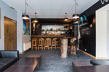 A bar with a menu written on the wall