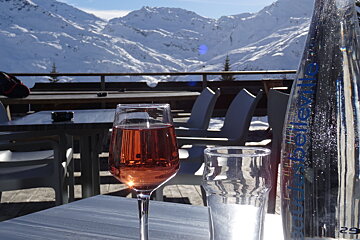a glass of rose on a table