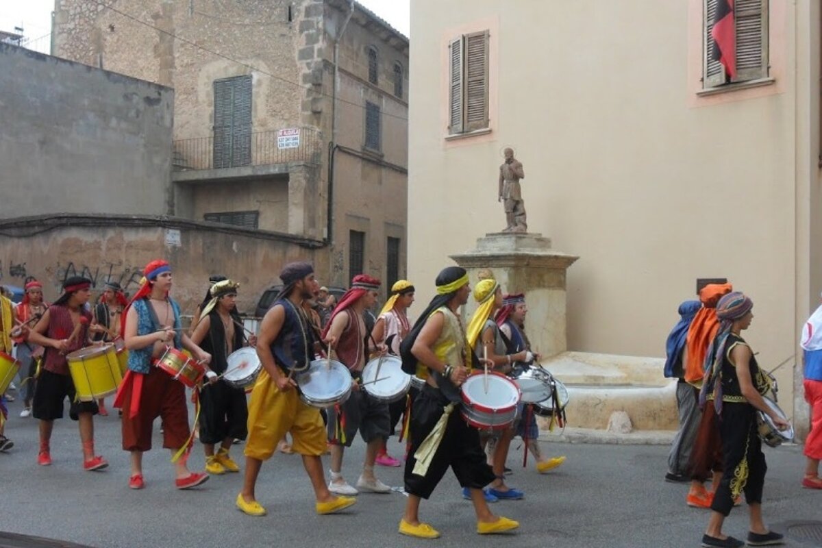 brightly coloured drummers at a festival in Mallorca