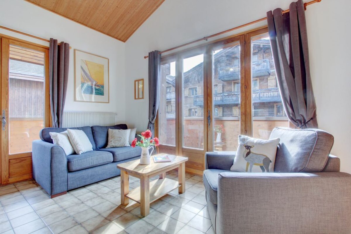 A living room with a couch a chair and a coffee table