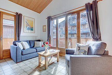A living room with a couch a chair and a coffee table