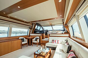 A living room on a boat with a table and chairs