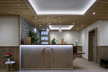 A wooden reception desk with the letter c on it
