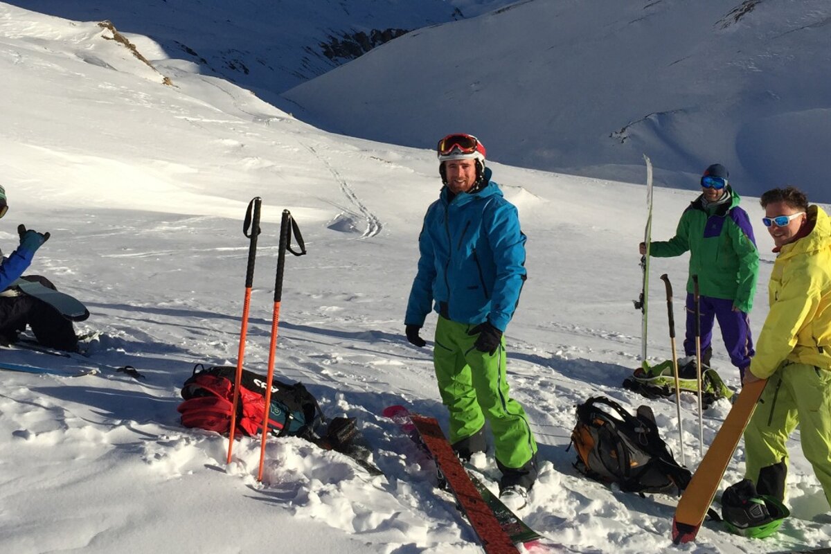 A group of skiers are standing in the snow