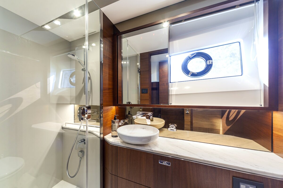 A bathroom on a boat with a sink and a mirror
