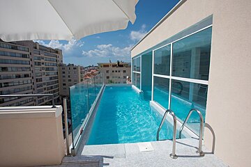 A swimming pool on the roof of a building