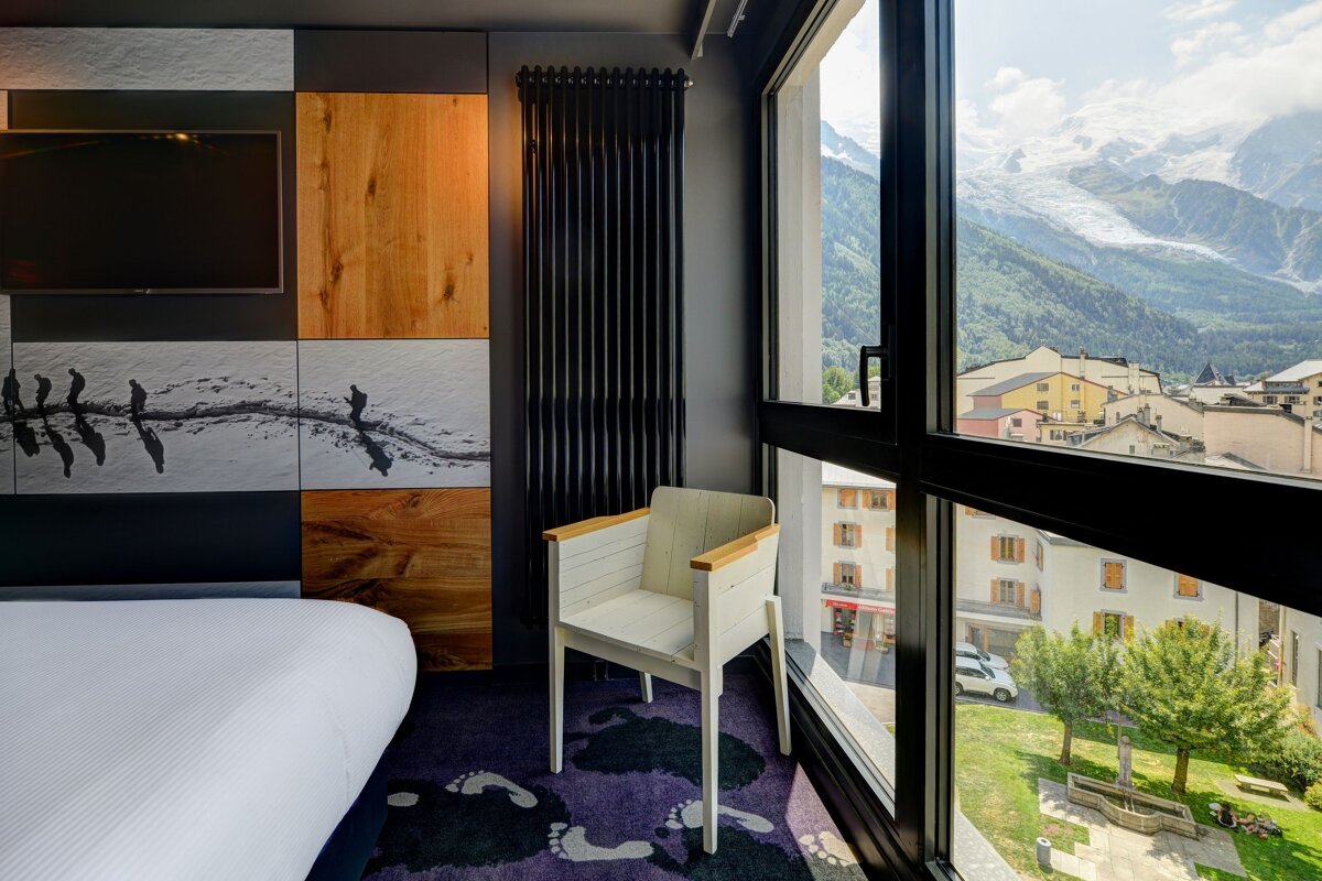 A hotel room with a view of the mountains