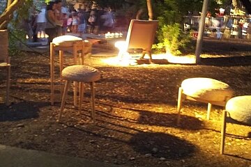 some round wicker stools for sale at an artists fair