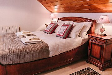 A bedroom with a bed and two lamps with hearts on them