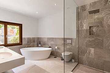 A bathroom with a bathtub and a toilet