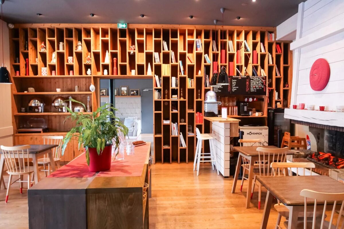 A restaurant with tables and chairs and a sign that says ' shack ' on it