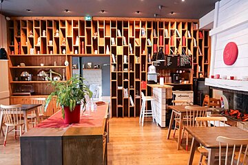 A restaurant with tables and chairs and a sign that says ' shack ' on it