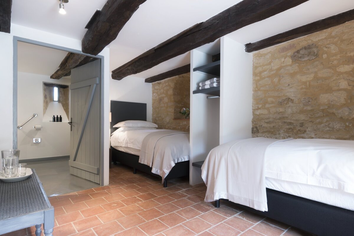 A bedroom with two beds and a sliding door