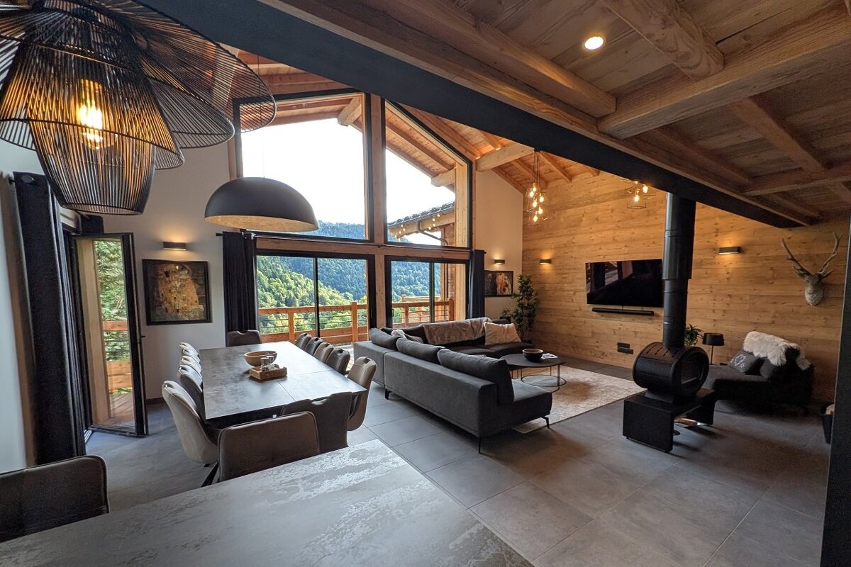 A living room with a large couch and a dining table