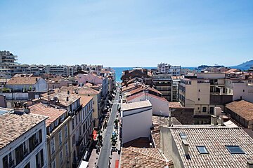An aerial view of a city with lots of buildings and roofs