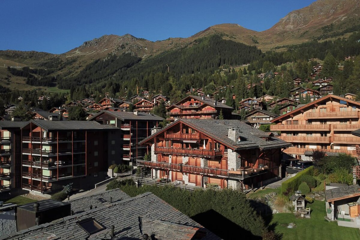 A row of buildings with a mountain in the background