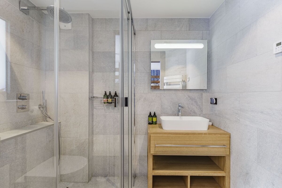 A bathroom with a sink a toilet and a shower